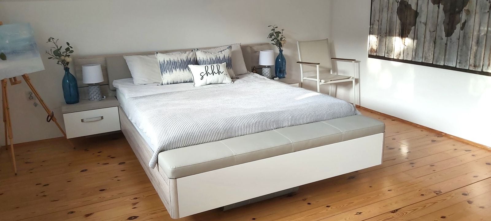 Cozy bedroom with a double bed and wooden floor in a house, Krimovica, Montenegro. Modern interior.