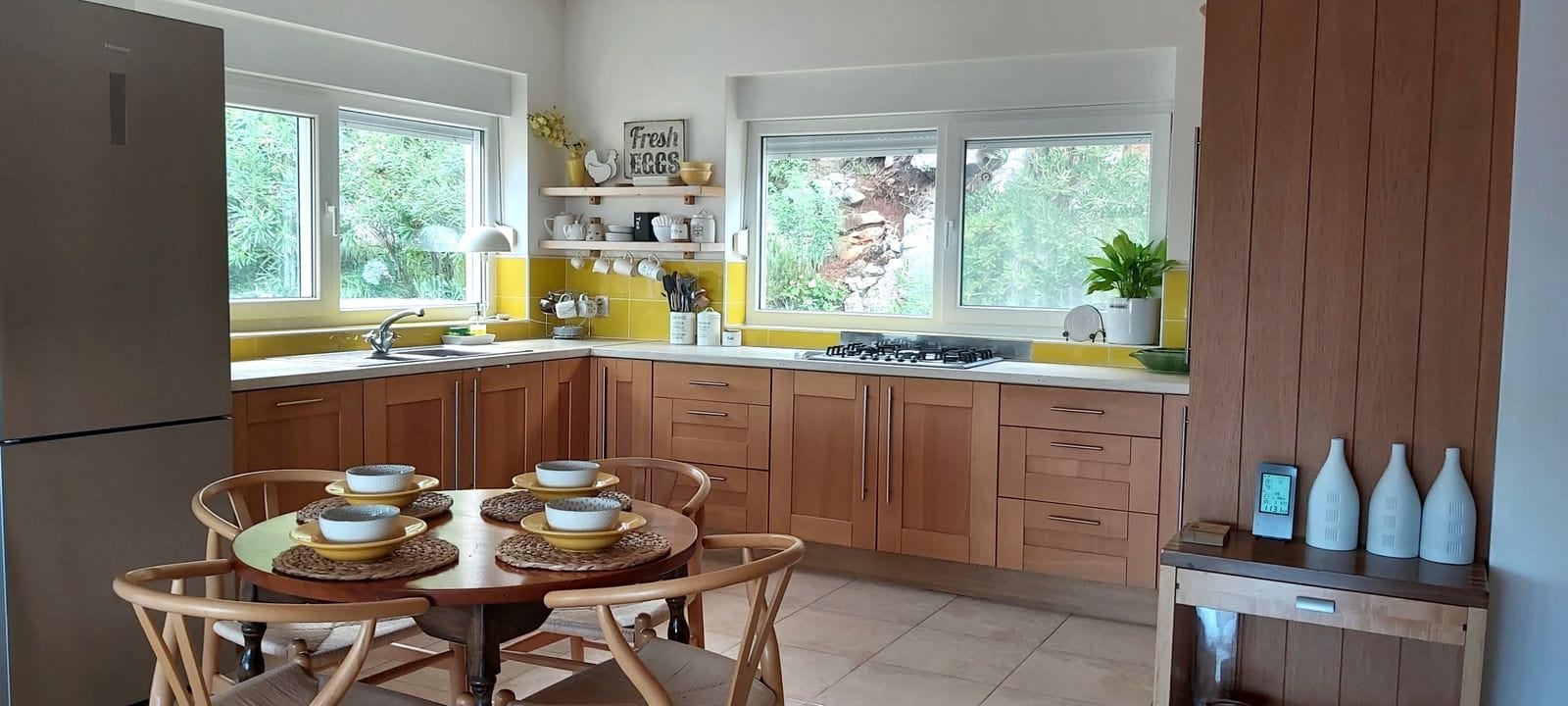 Cozy kitchen with wooden cabinetry and dining area in a house, Krumovitsa, Montenegro.