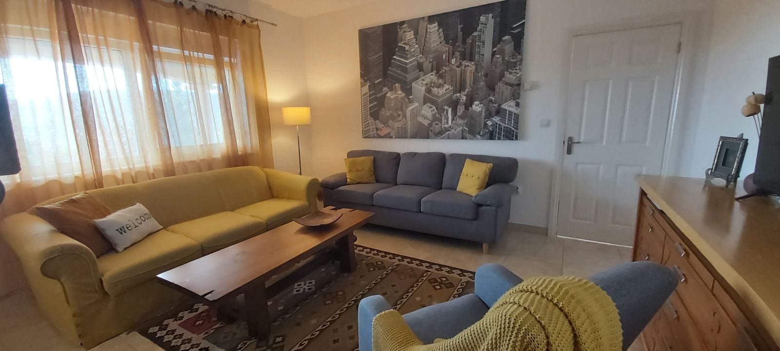 Cozy living room in a house, Krimovica, Montenegro: two sofas, a coffee table, a rug, and a painting on the wall.