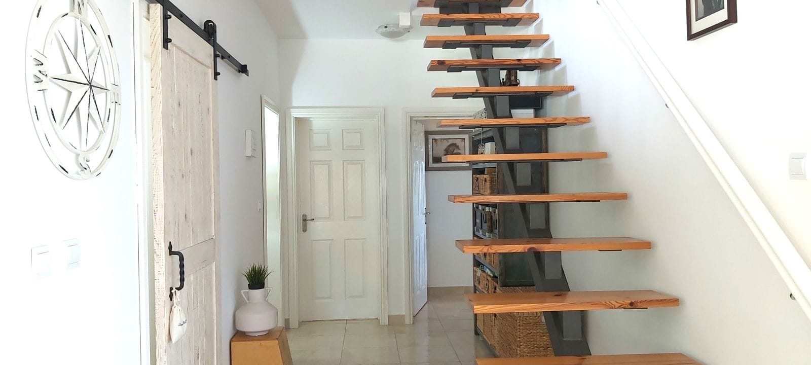 Modern wooden staircase in the interior of a house in Krimovica, Montenegro: stylish design and light finish.