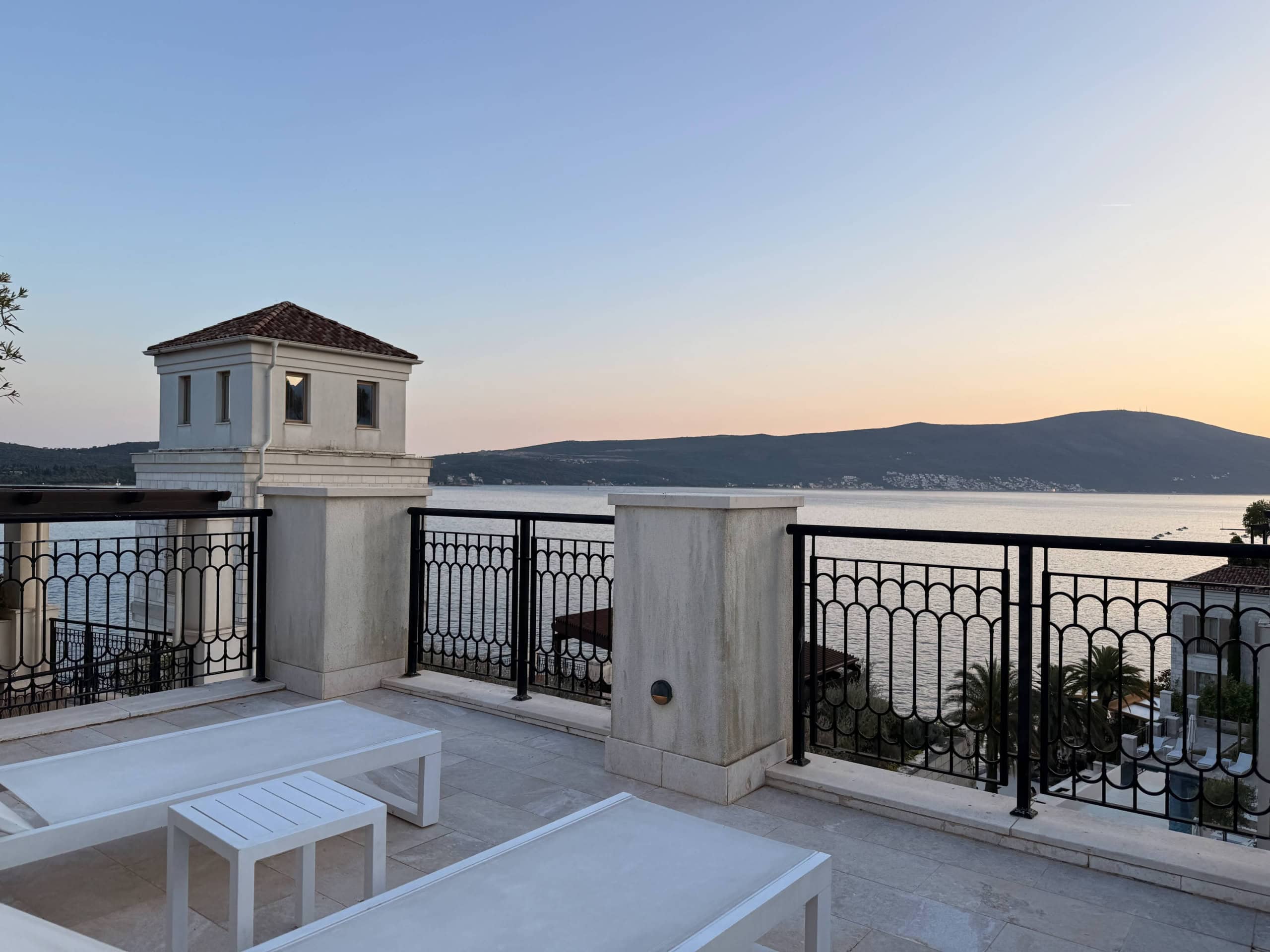 Terrace with sun loungers and panoramic views of the sea and mountains in a luxury residential complex, Tivat, Montenegro.