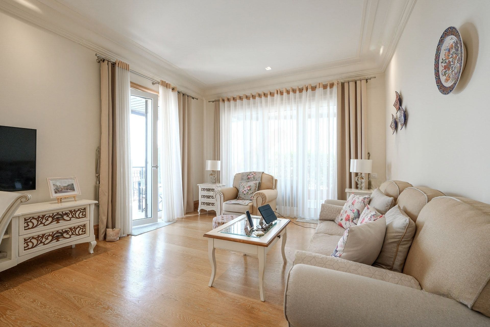 Bright classic-style living room with soft furniture and access to the balcony in an apartment, Tivat, Montenegro.
