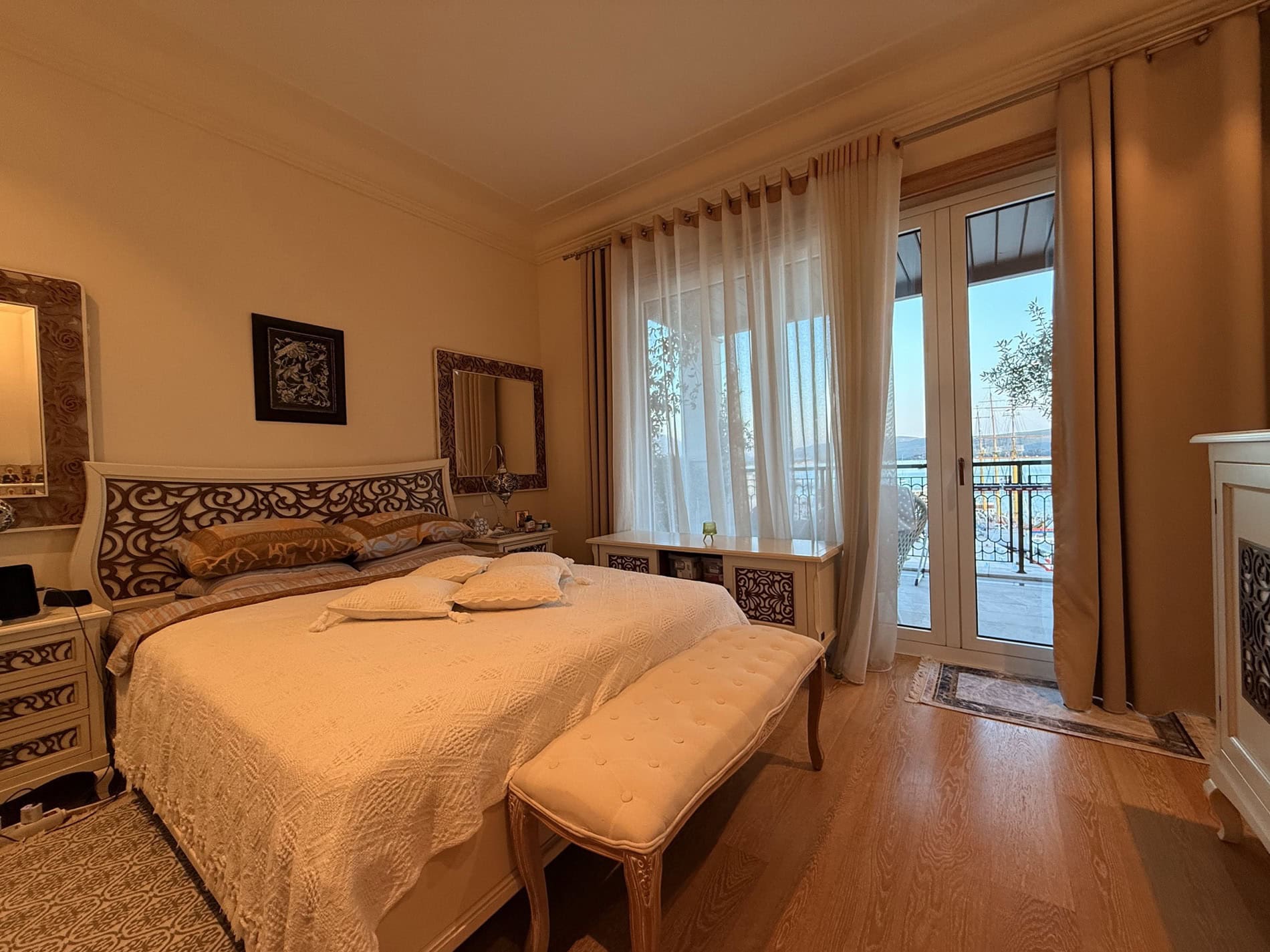 Cozy bedroom with a double bed and sea view in an apartment in Tivat, Montenegro. Bright interior with a terrace.