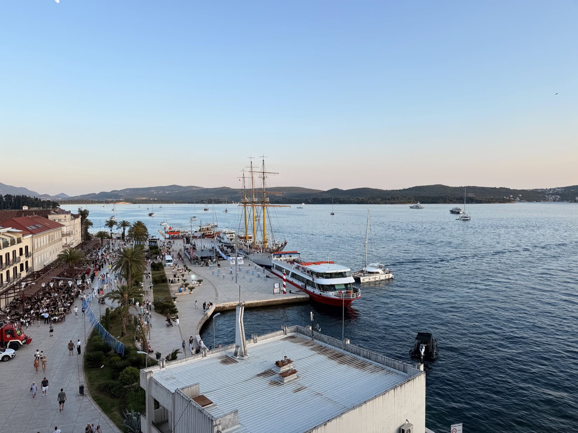 Panoramic view of the Tivat waterfront and marina, Montenegro: a pier with yachts, pleasure boats, and a seascape.