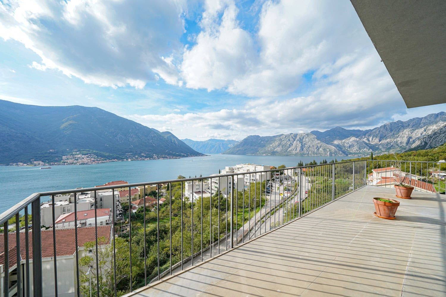 Spacious balcony with panoramic views of Kotor Bay and the mountains in Dobrota, Montenegro.