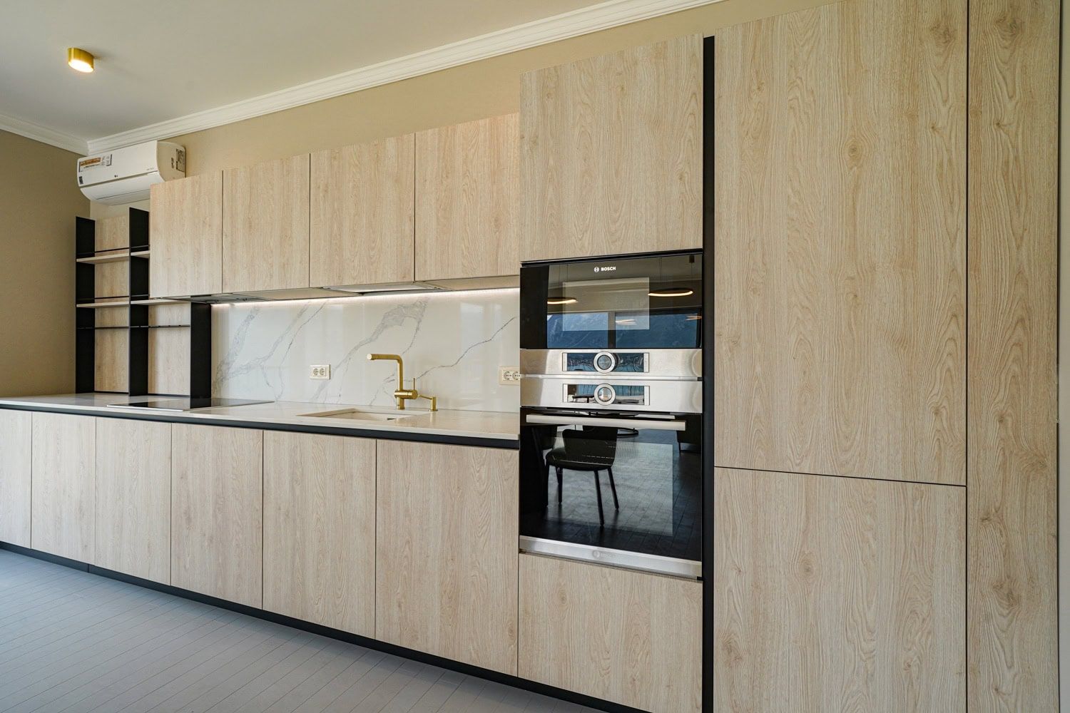 Modern kitchen with wood-look fronts and Bosch appliances in an apartment, Dobrota, Montenegro.