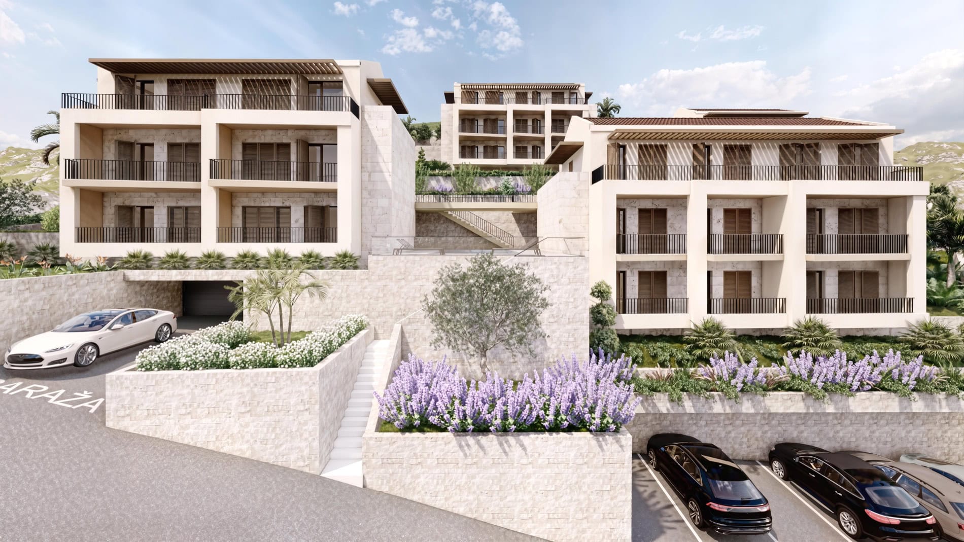 Modern residential complex in Muo, Montenegro: multi-level buildings with stone finishes, terraces, and parking.
