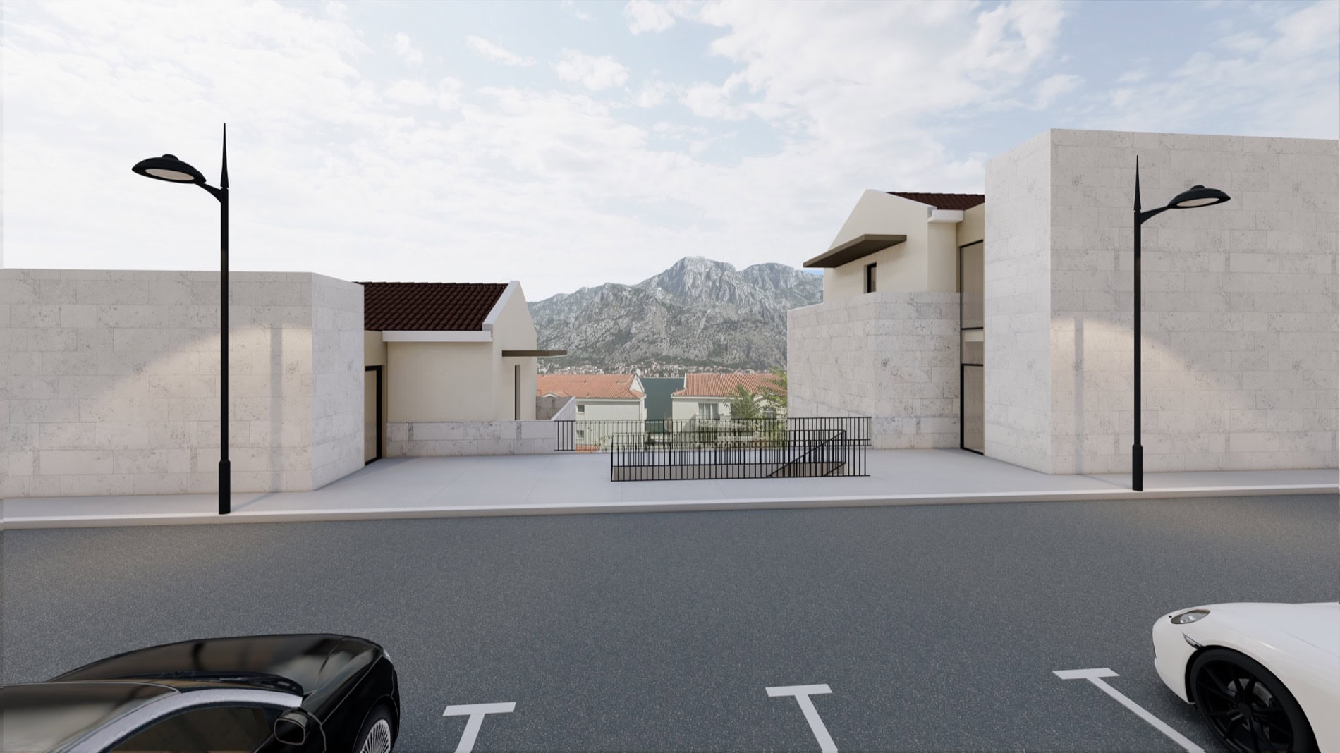 Modern residential complex in Muo, Montenegro: view of villas with stone cladding, parking, and panoramic mountain views.