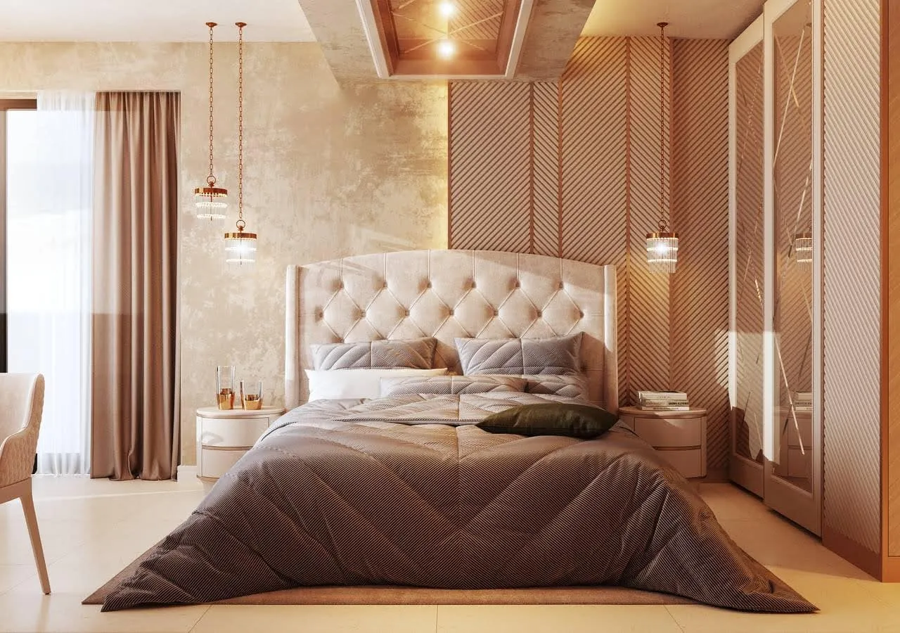 Modern bedroom featuring a large bed with tufted headboard, pendant lights, and built-in wardrobe.