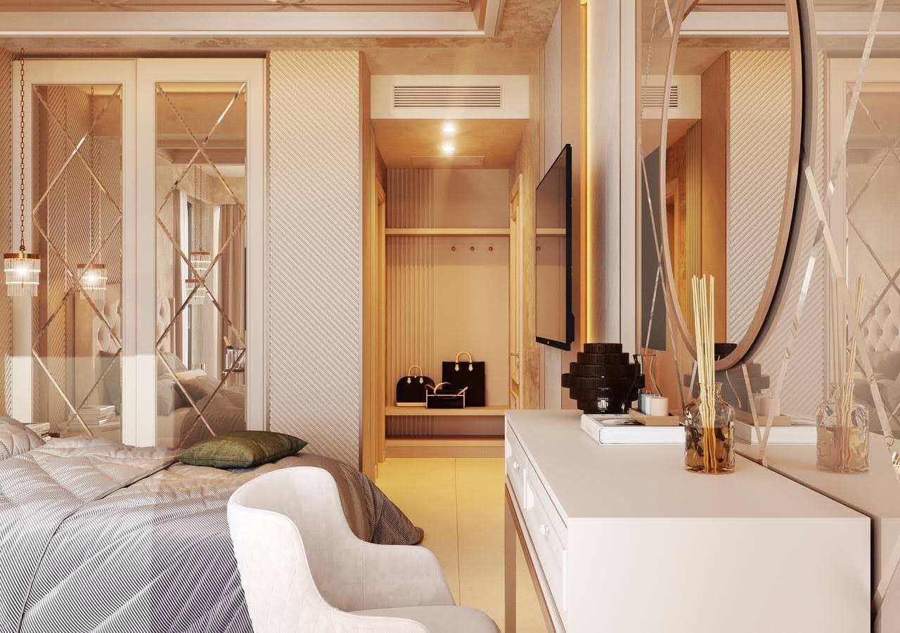 Interior of a modern bedroom in a villa in Petrovac, Montenegro: mirrored wardrobe, vanity table, and walk-in closet area.