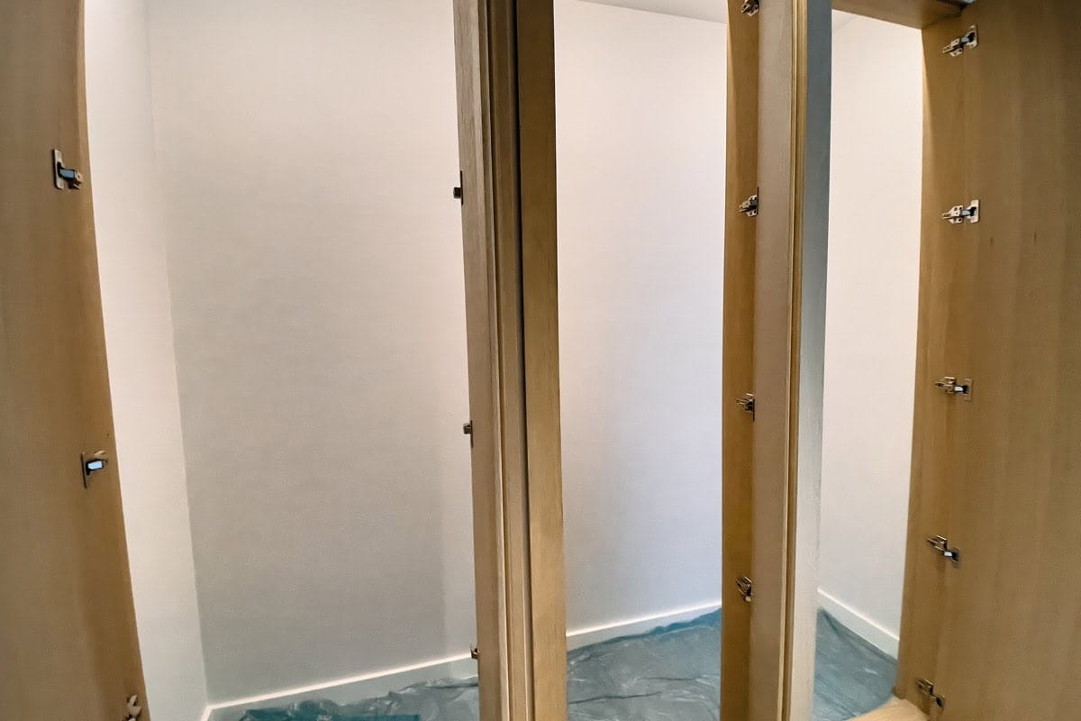 Built-in wardrobe with wooden fronts in a new apartment in Tivat, Montenegro, at the finishing stage.