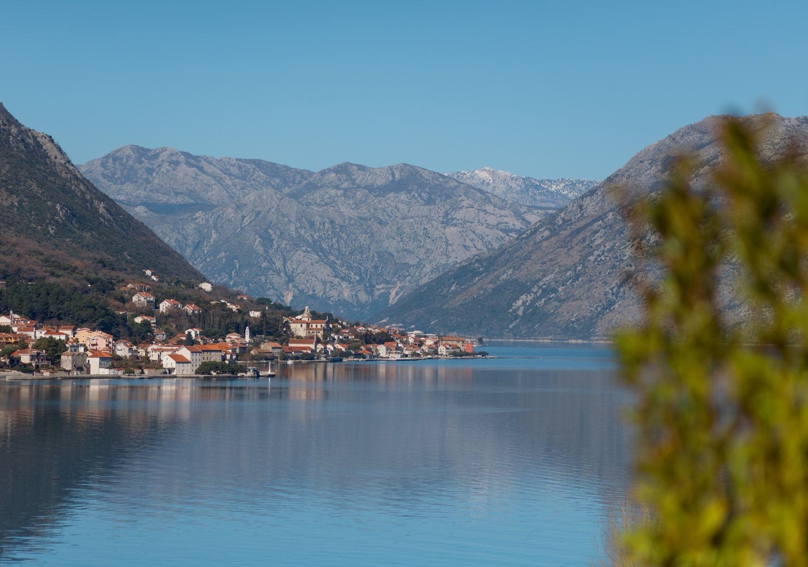 Panoramic view of Kotor Bay and the town of Dobrota in Montenegro with mountain scenery and coastal houses.