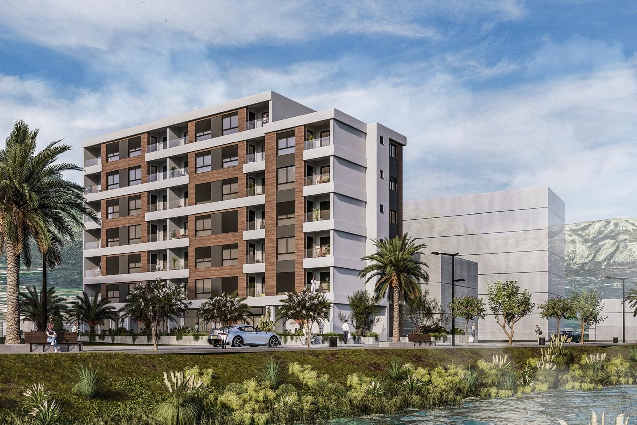 Modern residential complex in Bar, Montenegro: facade with balconies, panoramic windows, and landscaped grounds.