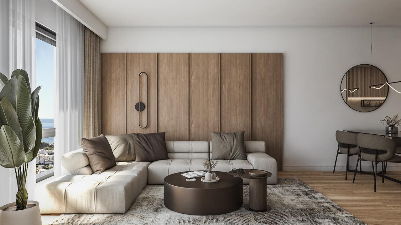Modern living room in a residential complex in Bar, Montenegro: light sofa, wooden panels, panoramic sea view, and stylish decor.