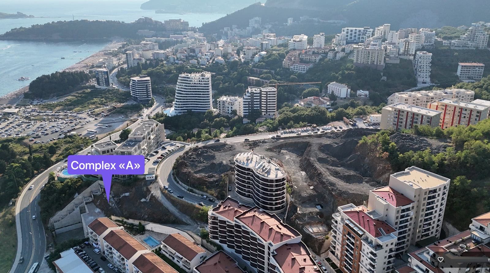 Aerial view of a residential complex in Bečići, Montenegro: a panorama of the area with modern buildings and the seaside.
