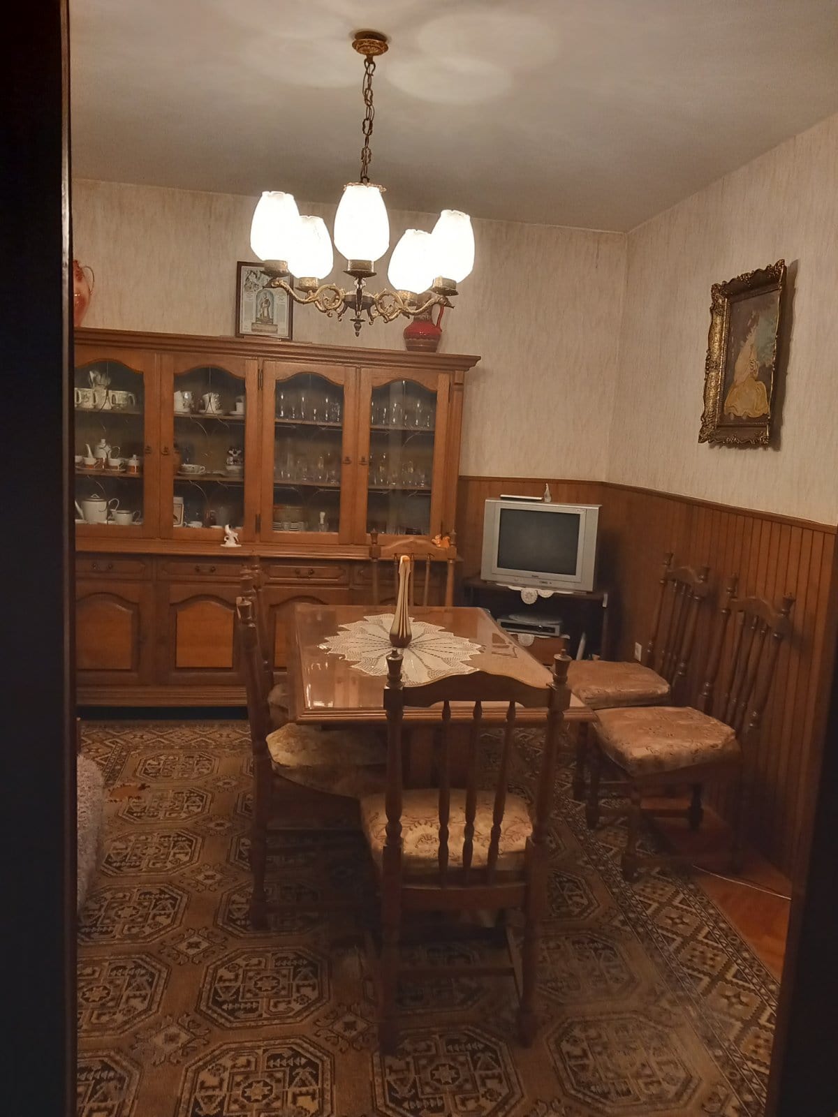Classic living room with wooden furniture and a dining area in a house for sale in Igalo, Montenegro.
