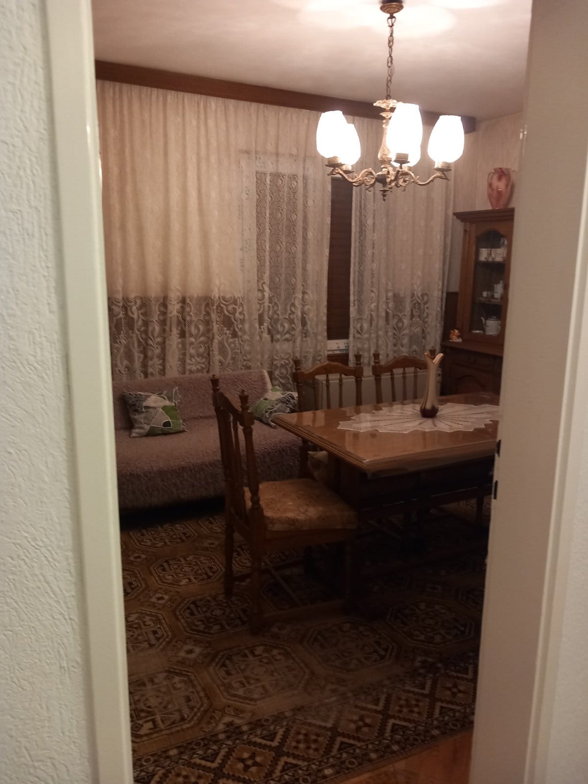Cozy living room with dining area and classic furniture in a house for sale in Igalo, Montenegro.