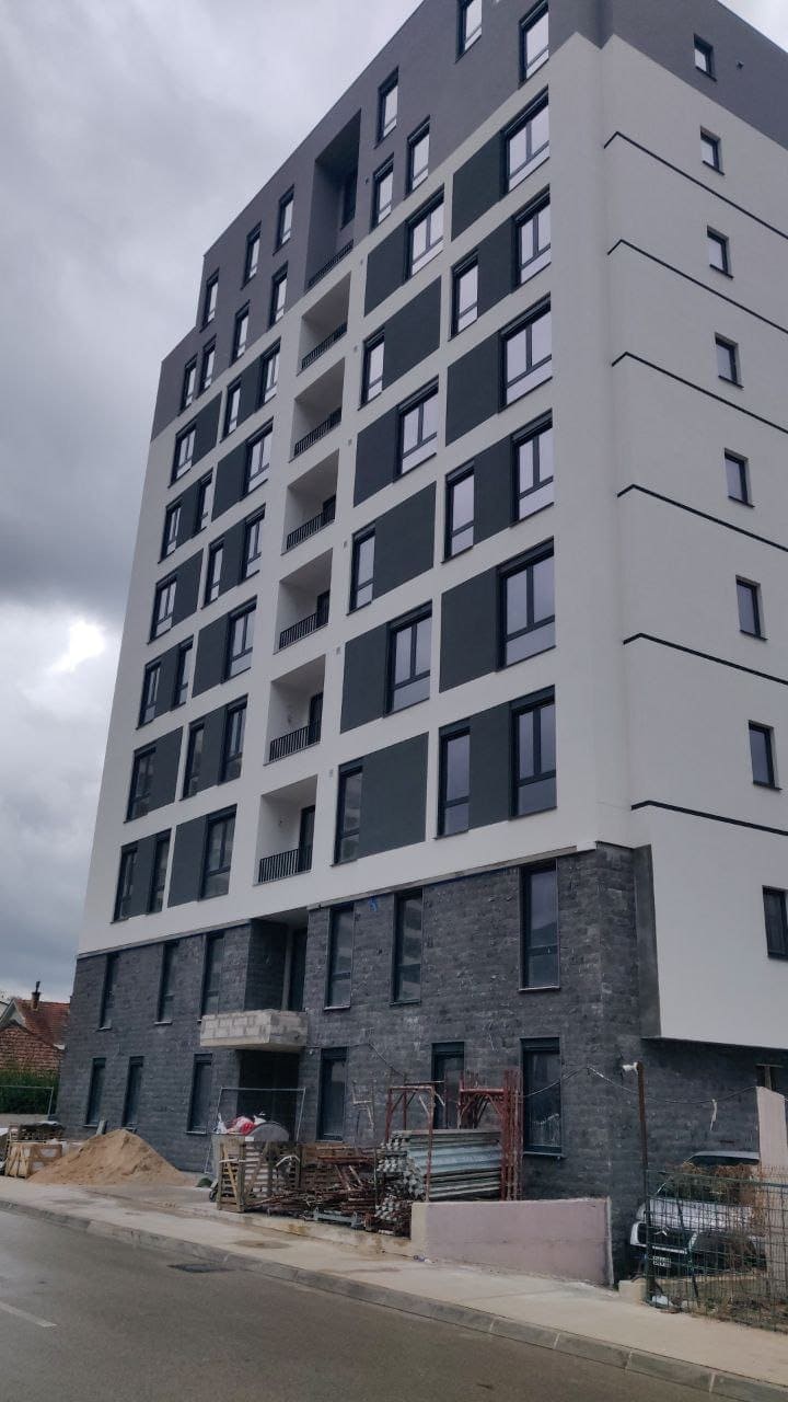 Modern apartment building with stone facade finish in Bar, Montenegro: view of the building under construction.