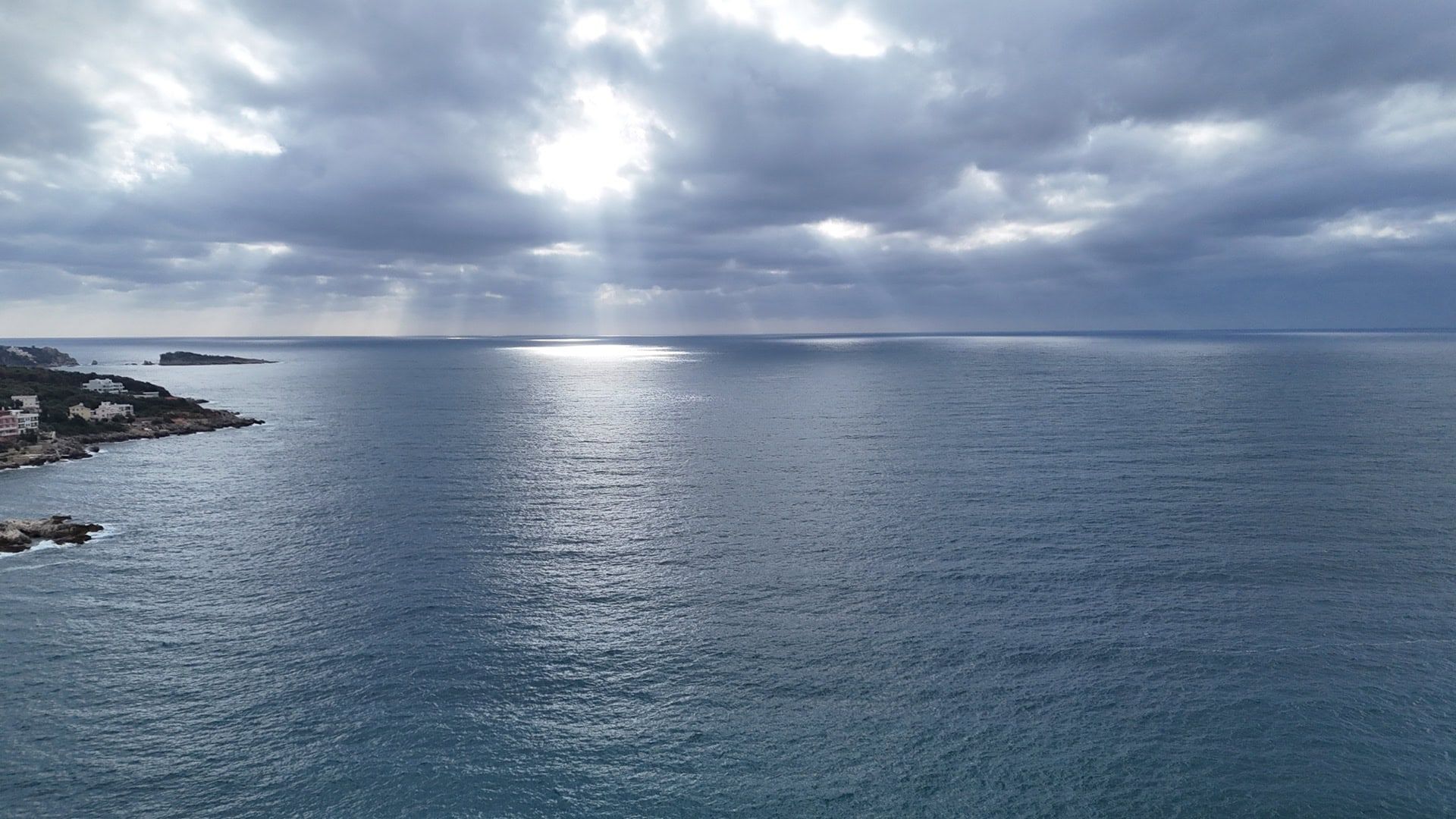 Panoramic view of the Adriatic Sea from a plot of land in the village of Utjeha, Montenegro, with a cloudy sky.