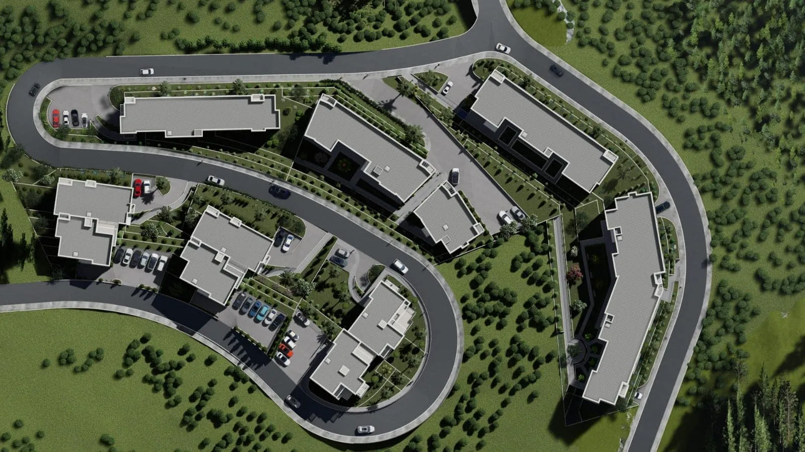 Aerial view of a residential complex with houses, roads, and parking surrounded by greenery.