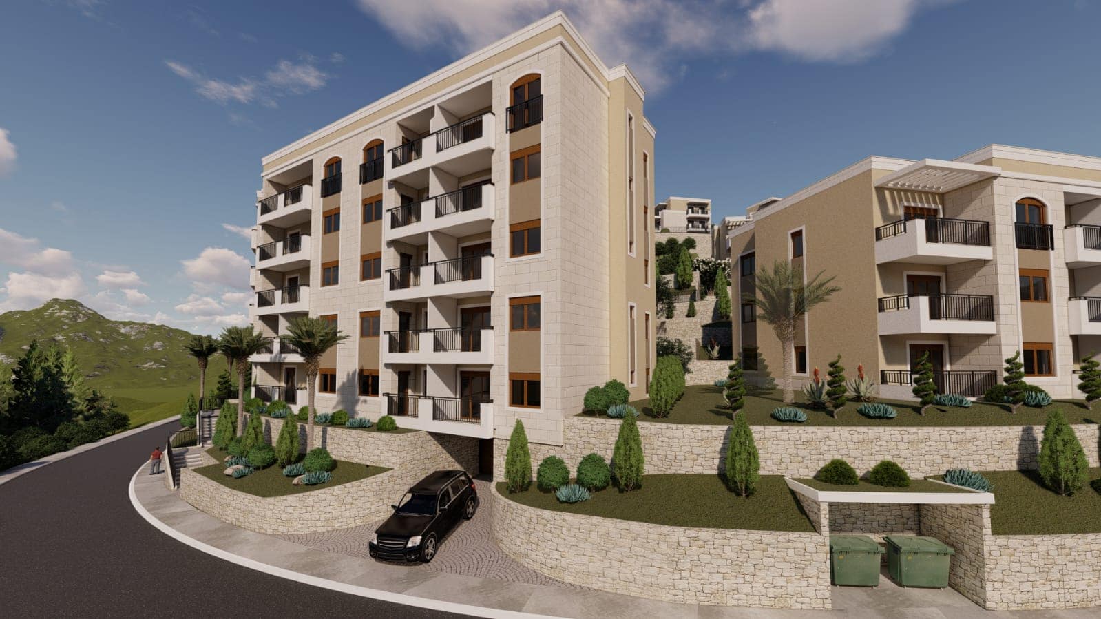 Modern residential complex in Budva, Montenegro: stone facade, balconies with railings, and landscaped grounds.