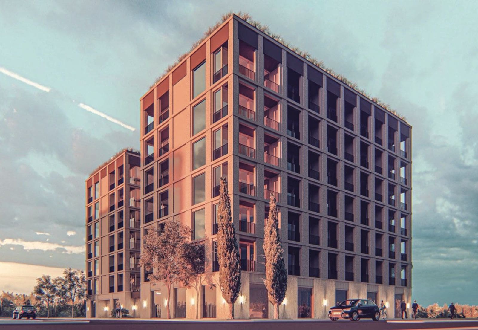 Modern residential complex in Budva, Montenegro: facade of a multi-story building with panoramic windows and terraces.