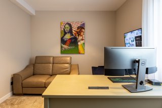 Home office with a leather sofa and computer desk in a villa in Bečići, Montenegro. Modern interior.