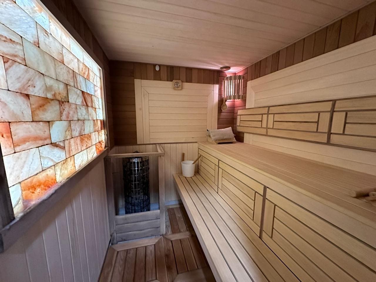 Sauna with wood paneling and a Himalayan salt wall in a villa in Bečići, Montenegro.