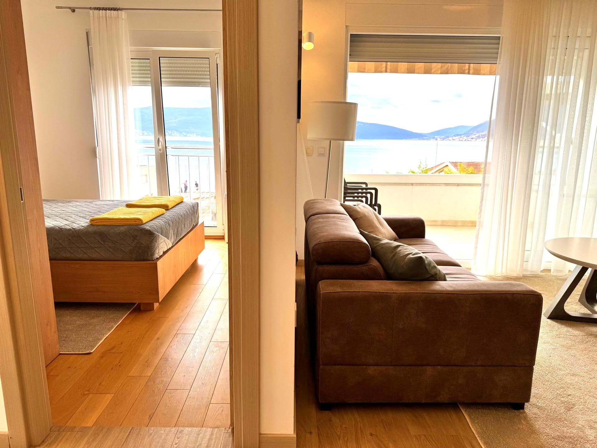Apartment interior in Tivat, Montenegro: a living room with a brown sofa and a bedroom with sea view and terrace.