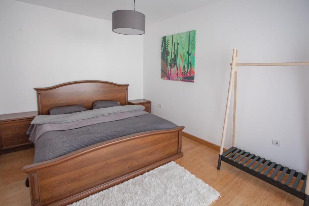 Bright bedroom with a double bed in an apartment in Budva, Montenegro: wooden furniture and laminate flooring.