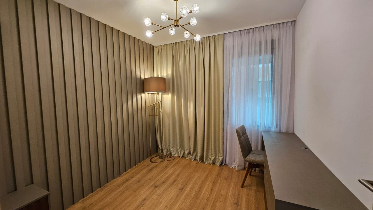 Modern bedroom with wall slats, a desk, and stylish lighting in an apartment, Budva, Montenegro.