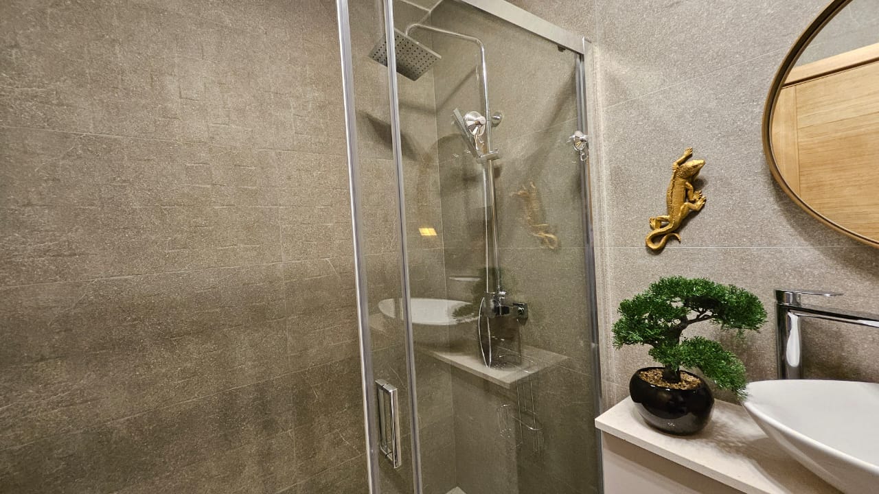 Modern bathroom with a shower cabin in an apartment in Budva, Montenegro: stylish finishes and decor.