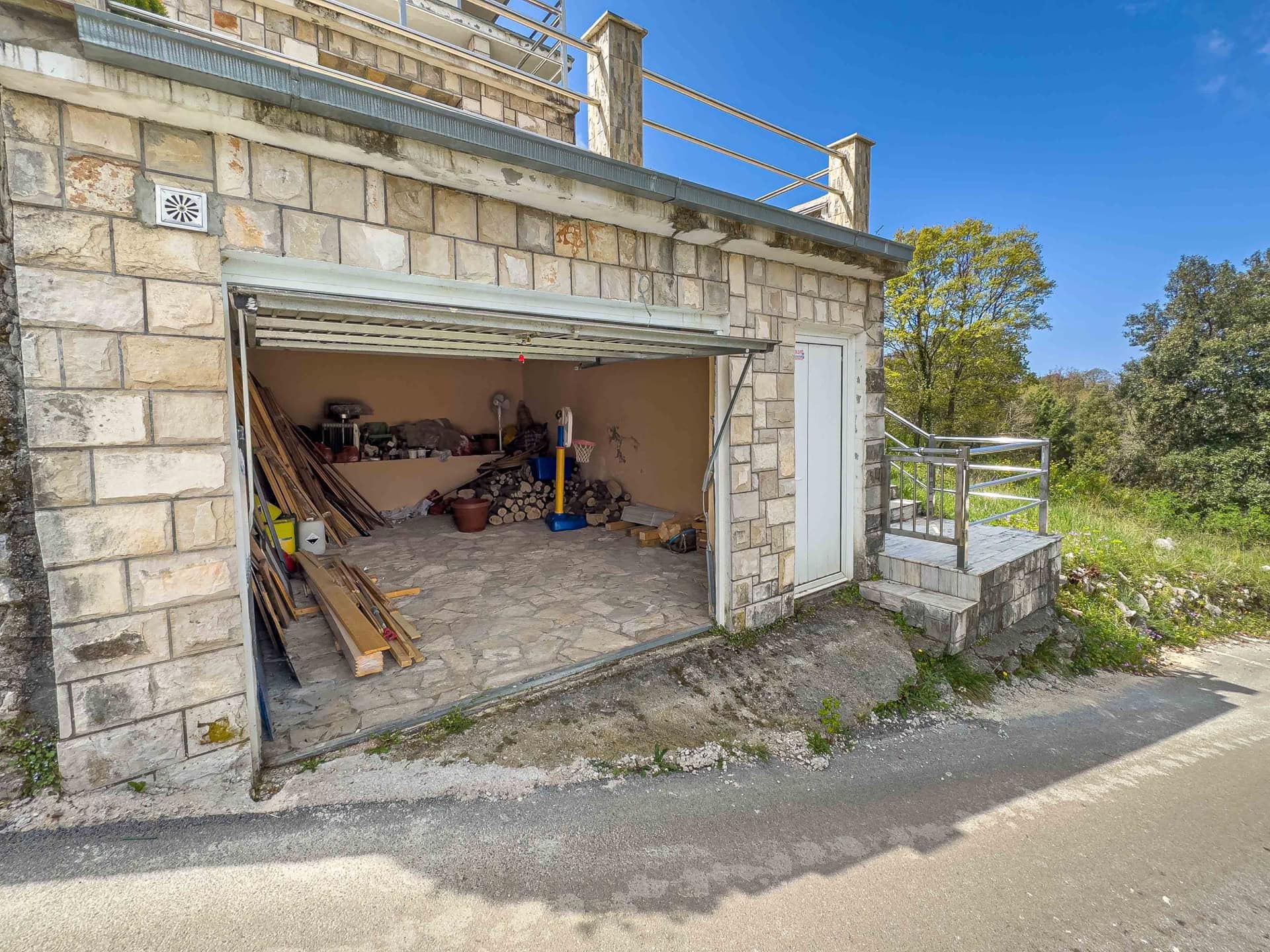 Stone garage with a terrace in a house for sale in Utjeha, Montenegro: view of the utility room and adjacent area.