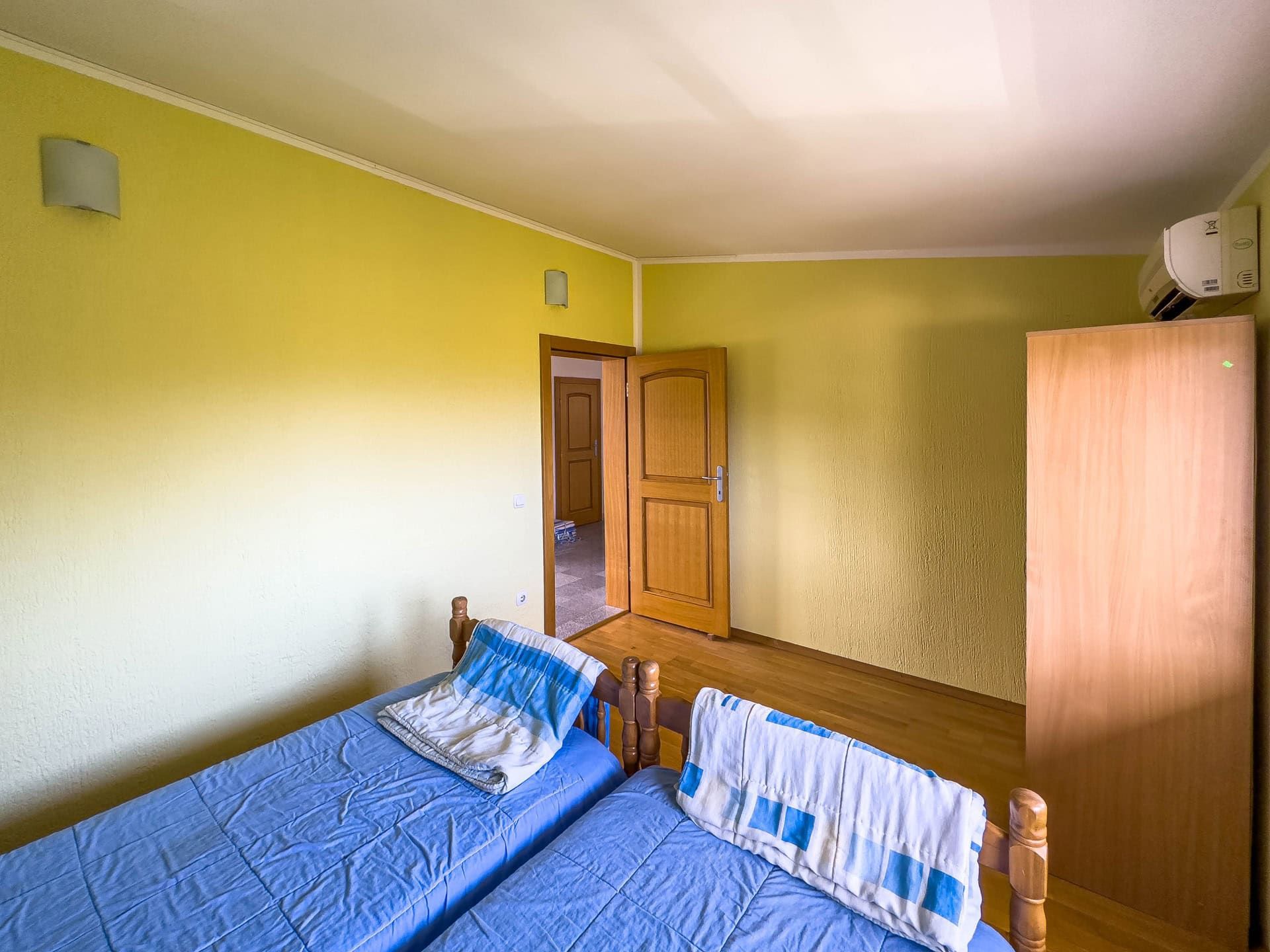 Bedroom with two beds, a wardrobe, and air conditioning in a house for sale, Utjeha, Montenegro.