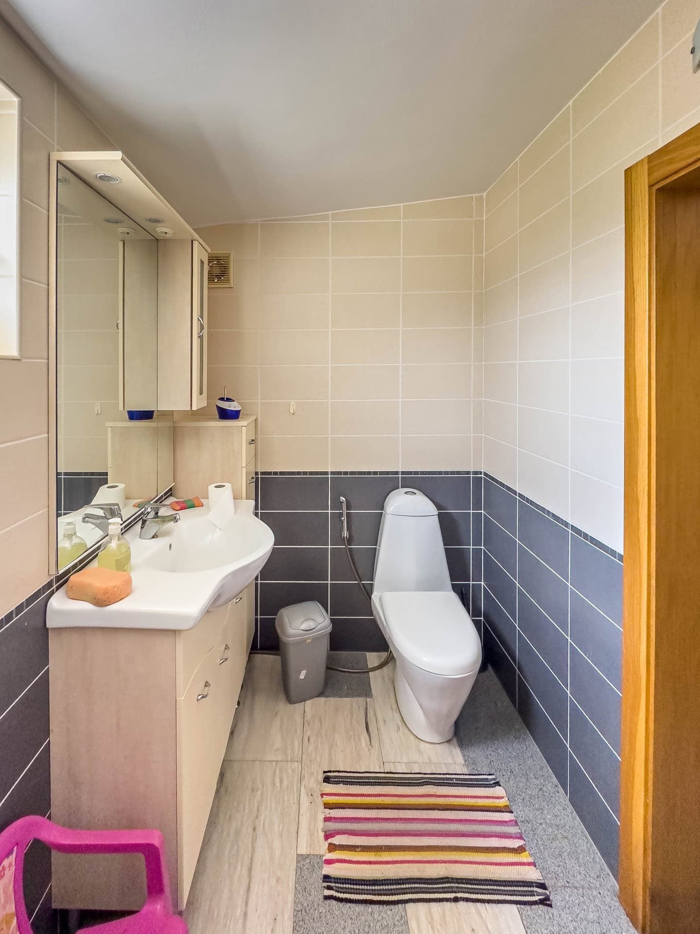 Bathroom in a house, Utjeha, Montenegro: light tiles, vanity with sink, mirror, and modern fixtures.