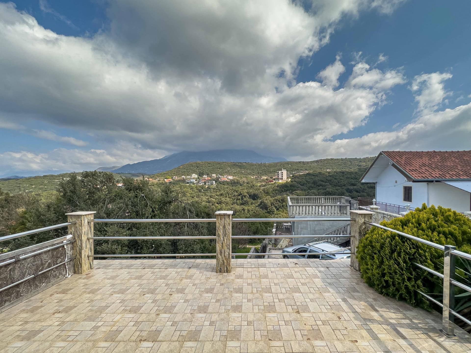 Spacious terrace with panoramic views of the mountains and greenery in a house for sale, Utjeha, Montenegro.
