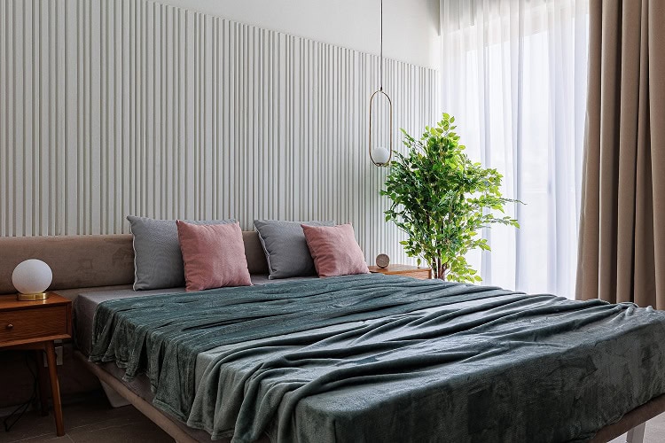 Modern bedroom in an apartment in Bečići, Montenegro: double bed, slatted wall feature, and panoramic window.