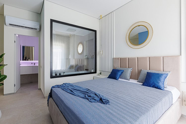 Modern bedroom in an apartment, Bečići, Montenegro: double bed, glass partition to the bathroom, air conditioning.