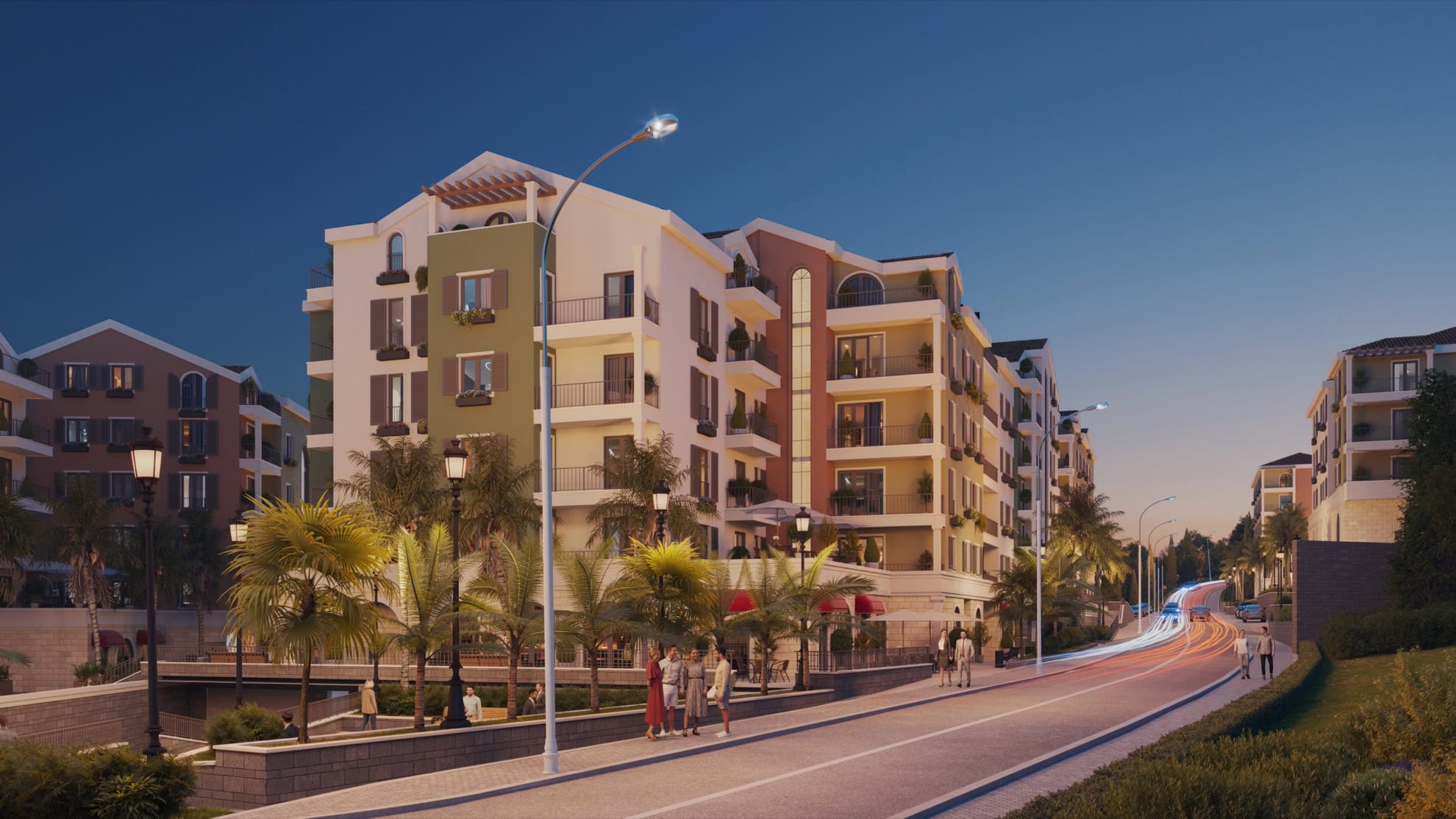 Modern residential complex in Tivat, Montenegro: building facade with balconies, palm trees, and evening street lighting.