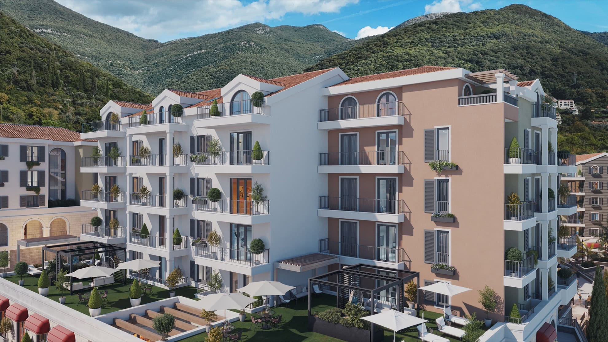 Modern residential complex in Tivat, Montenegro: building facade with terraces, balconies, and a view of the green mountains.