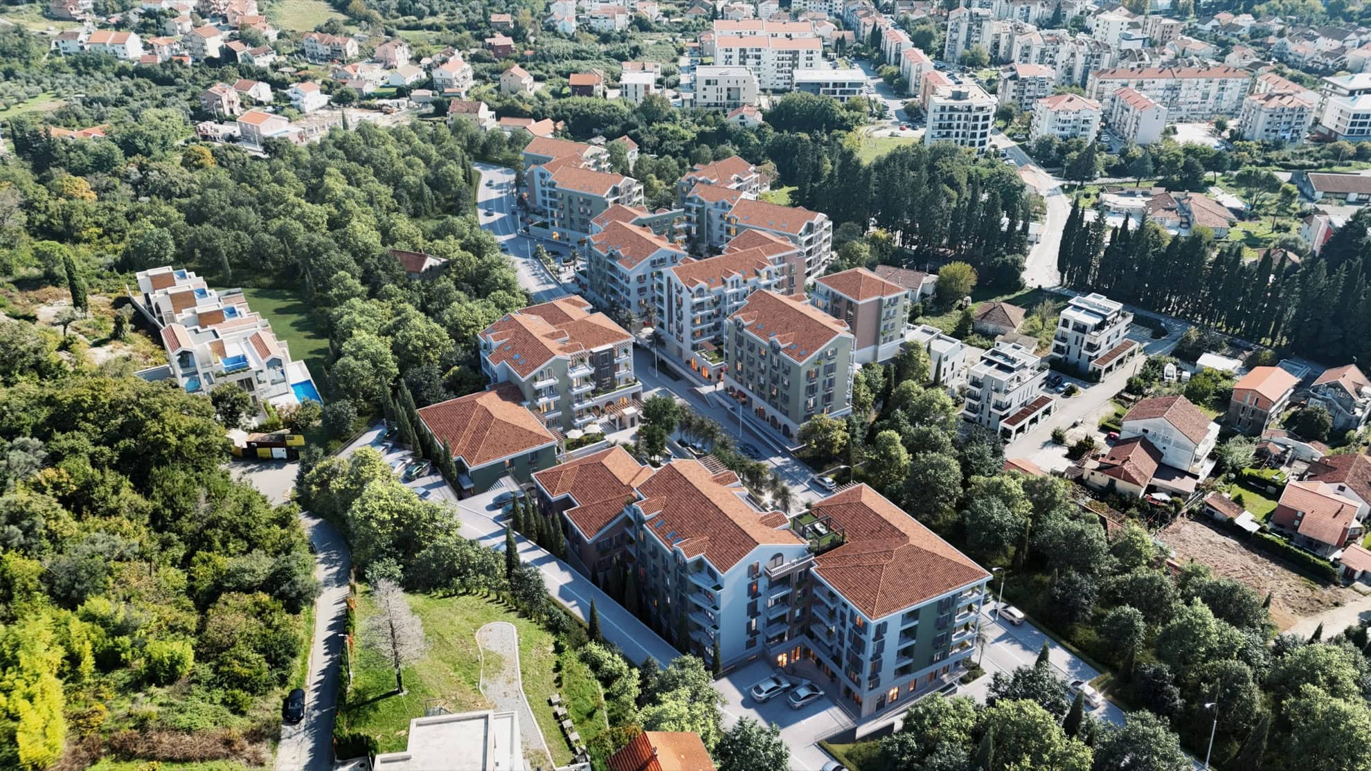 Aerial view of a residential complex with tiled roofs surrounded by greenery, Tivat, Montenegro.