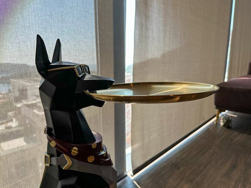 A dog figurine with a tray as decor in the interior of a modern penthouse living room in Bečići, Montenegro.