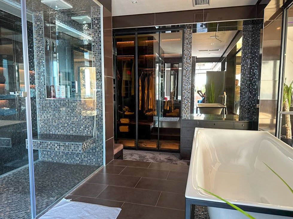 Modern bathroom with a shower and walk-in closet in a luxury penthouse, Becici, Montenegro.