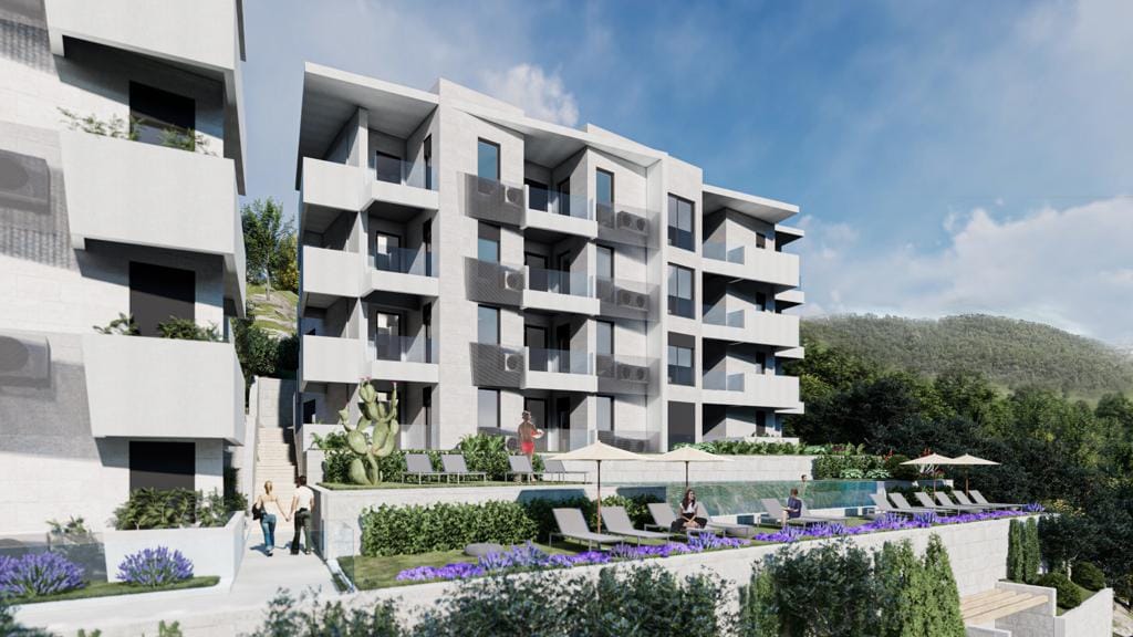 Modern residential complex with a pool and terraces in Petrovac, Montenegro: view of the facade and landscaped relaxation area.