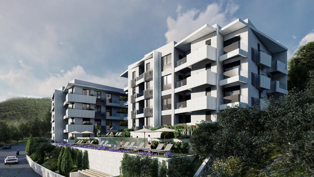 Modern residential complex with a pool and terraces in Petrovac, Montenegro: view of the building facades and leisure area.