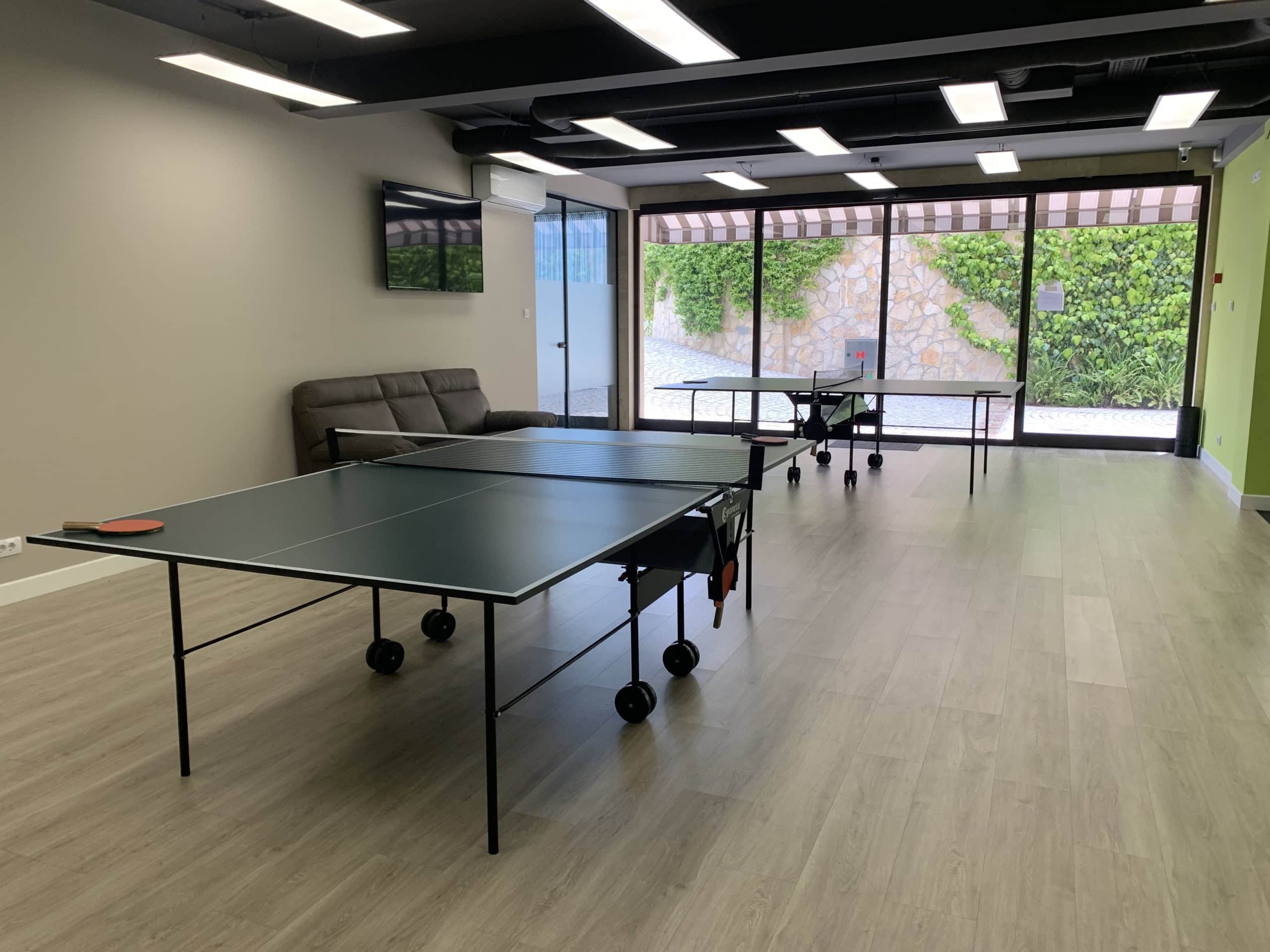 Game room with ping-pong tables in a residential complex, Kumbor, Montenegro: modern interior and panoramic windows.