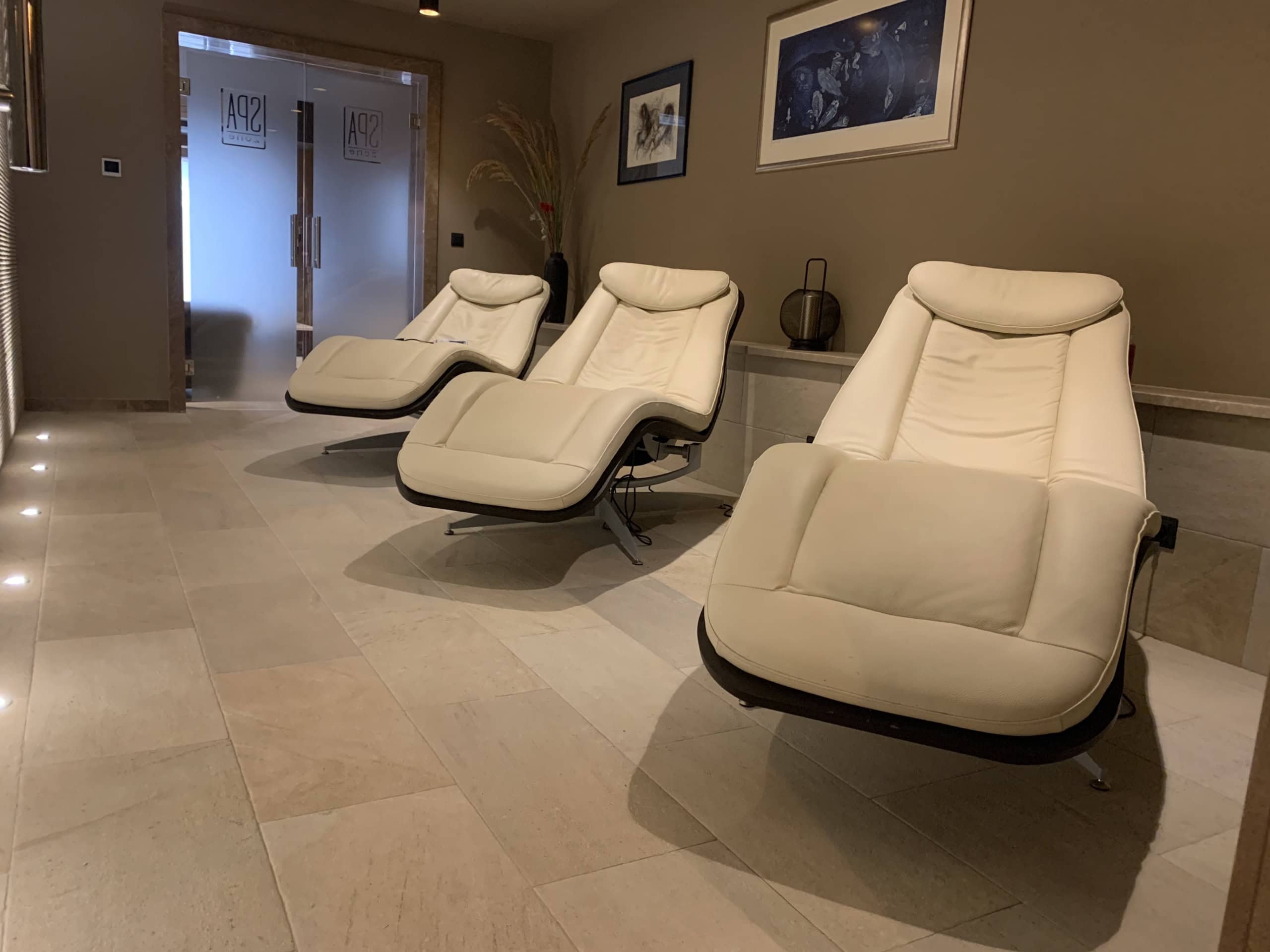 Relaxation area with light leather loungers in the spa center of a residential complex in Kumbor, Montenegro.