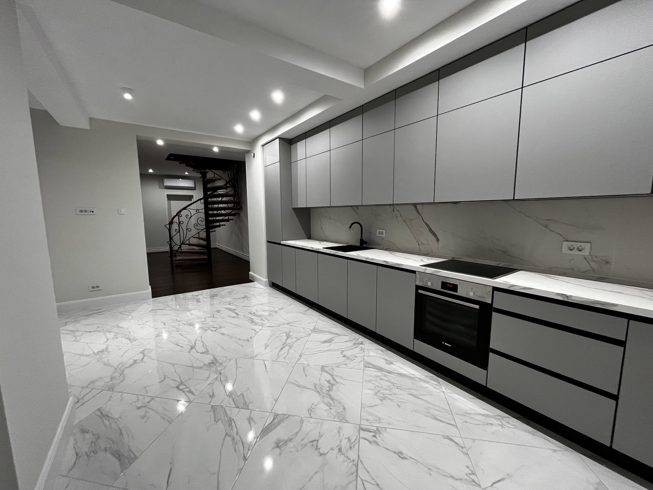 Modern kitchen with marble flooring and a spiral staircase in a residential complex, Kumbor, Montenegro