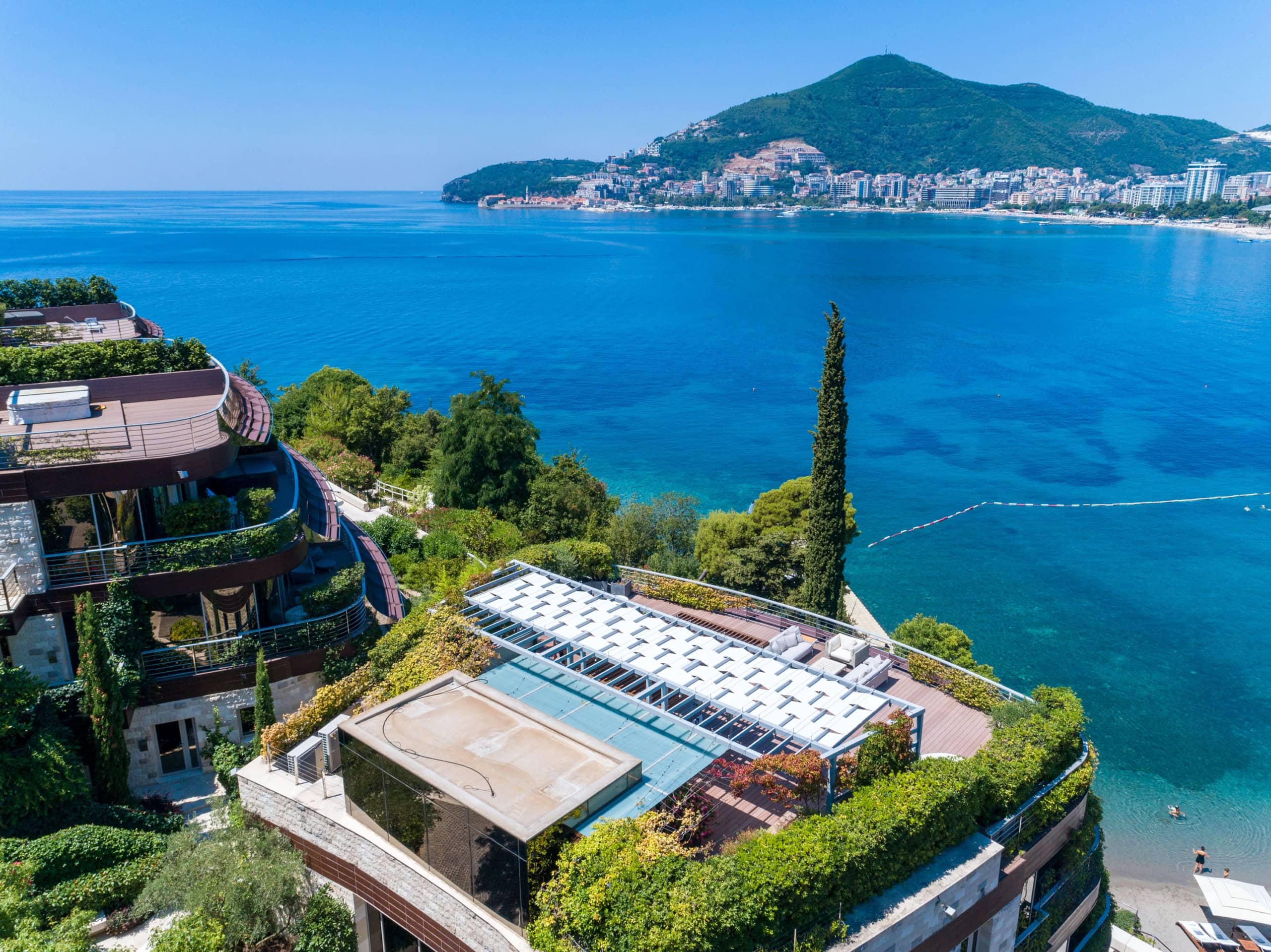 Luxury residential complex in Budva, Montenegro: view from the terrace of the sea, modern architecture, and landscape design.