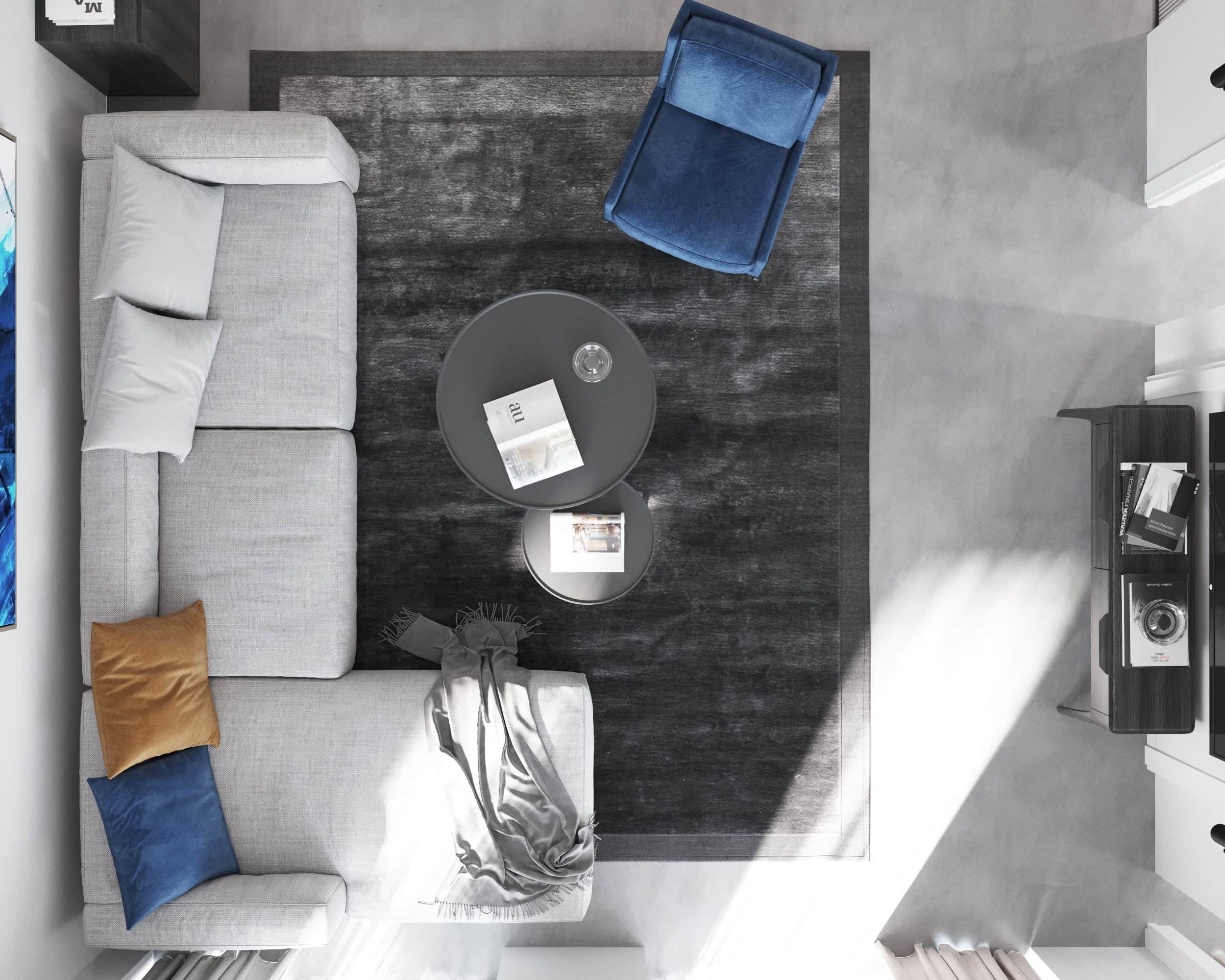 Top view of a modern living room in the Tivat residential complex, Montenegro: a gray sofa, a blue armchair, and round coffee tables.